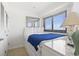 Bright bedroom space featuring a large window with blinds and a comfortable bed at 5905 S Kings Highway # 1206-C, Myrtle Beach, SC 29575