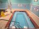 Indoor community hot tub with lift chair and safety rails, perfect for relaxation at 5905 S Kings Highway # 1206-C, Myrtle Beach, SC 29575