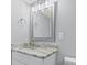 Stylish bathroom featuring modern vanity with stone countertop, framed mirror and designer lighting at 601 Mitchell Dr. # 207, Myrtle Beach, SC 29577