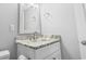 Well-lit bathroom featuring a framed mirror, a vanity with marble countertop, and toilet at 601 Mitchell Dr. # 207, Myrtle Beach, SC 29577