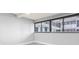 Bright, empty bedroom with a large window and a view of the interior hallway at 601 Mitchell Dr. # 207, Myrtle Beach, SC 29577