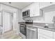Modern kitchen with stainless steel appliances, granite countertops, and white cabinetry at 601 Mitchell Dr. # 207, Myrtle Beach, SC 29577