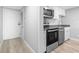 Modern kitchen with stainless steel appliances, granite countertops, and white cabinetry at 601 Mitchell Dr. # 207, Myrtle Beach, SC 29577