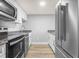 Modern kitchen with stainless steel appliances, granite countertops, and white cabinetry at 601 Mitchell Dr. # 207, Myrtle Beach, SC 29577