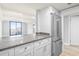 Bright kitchen with granite countertop, white cabinets, and stainless steel refrigerator and access to living room at 601 Mitchell Dr. # 207, Myrtle Beach, SC 29577