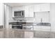 Bright kitchen featuring gray granite counters and stainless-steel appliances at 601 Mitchell Dr. # 207, Myrtle Beach, SC 29577