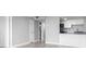 A hallway opens to a bright living room featuring a kitchen and a closet at 601 Mitchell Dr. # 207, Myrtle Beach, SC 29577