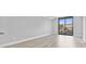 A spacious living room with wood floor and a sliding glass door to a balcony at 601 Mitchell Dr. # 207, Myrtle Beach, SC 29577