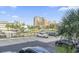 Condo building's parking lot with mature palm trees and clear blue skies at 601 Mitchell Dr. # 207, Myrtle Beach, SC 29577