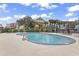 Outdoor pool area with crystal clear pool, lush landscaping, and plenty of space for relaxation at 601 Mitchell Dr. # 207, Myrtle Beach, SC 29577