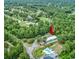 Aerial view of a condo complex nestled amidst lush greenery with a community pool at 601 Putters Ln. # H209, Little River, SC 29566