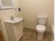 Neutral bathroom equipped with a single sink vanity, tiled floor, and standard toilet at 601 Putters Ln. # H209, Little River, SC 29566