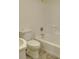 Clean, all-white bathroom with standard fixtures including a toilet, sink, and tub-shower combo at 601 Putters Ln. # H209, Little River, SC 29566