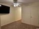 Comfortable bedroom showcases a ceiling fan, a flat screen TV and neutral colored carpet at 601 Putters Ln. # H209, Little River, SC 29566
