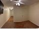 Spacious bedroom boasts neutral tones, ceiling fan, and doorway leading to a secondary space at 601 Putters Ln. # H209, Little River, SC 29566