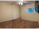 Cozy bedroom displays a large window for natural light, ceiling fan and neutral colored carpet at 601 Putters Ln. # H209, Little River, SC 29566