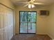 Well-lit bedroom with a sliding glass door to the balcony, ceiling fan, and spacious closet at 601 Putters Ln. # H209, Little River, SC 29566