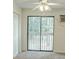 Serene bedroom featuring a sliding glass door to a balcony, offering nature views at 601 Putters Ln. # H209, Little River, SC 29566