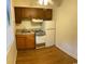 Cozy kitchen features wood cabinets, standard appliances, and vinyl flooring for easy maintenance at 601 Putters Ln. # H209, Little River, SC 29566