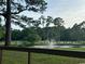 Picturesque pond with fountain on the Eagle Nest golf course at 601 Putters Ln. # H209, Little River, SC 29566