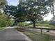 Road going through a wooded area, next to a golf course at 601 Putters Ln. # H209, Little River, SC 29566