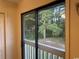 A sliding glass door offers lovely views from a private balcony overlooking lush green space at 601 Putters Ln. # H209, Little River, SC 29566