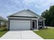 Charming single-story home with gray siding, a two-car garage, and a well-manicured lawn at 602 Muster Field Ct., Conway, SC 29526