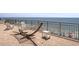 Relaxing oceanfront balcony with chairs, hammock, and views of the beach at 6900 N Ocean Blvd. # 915, Myrtle Beach, SC 29572