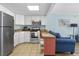 Galley kitchen with white cabinetry, stainless appliances, and bar seating overlooking the living area at 6900 N Ocean Blvd. # 915, Myrtle Beach, SC 29572