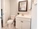 Bathroom featuring a white vanity with dark hardware and a decorative mirror at 698 Riverwalk Dr. # 304, Myrtle Beach, SC 29579