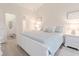 A beautifully staged bedroom with a white bed, lamps, and connected bathroom at 698 Riverwalk Dr. # 304, Myrtle Beach, SC 29579