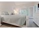 A bedroom with lots of natural light, white furniture, and a TV at 698 Riverwalk Dr. # 304, Myrtle Beach, SC 29579