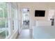 Bright bedroom featuring a screened porch, TV, dresser, and ample natural light at 698 Riverwalk Dr. # 304, Myrtle Beach, SC 29579