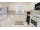 Charming kitchen with white cabinets, granite countertops, and modern appliances at 698 Riverwalk Dr. # 304, Myrtle Beach, SC 29579
