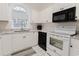Well-equipped kitchen featuring white cabinets, granite counters, and black appliances at 698 Riverwalk Dr. # 304, Myrtle Beach, SC 29579