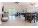 Bright living room features vaulted ceiling, hardwood floors, and sliding glass doors to balcony at 698 Riverwalk Dr. # 304, Myrtle Beach, SC 29579