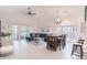 Bright living room features vaulted ceiling, hardwood floors, and sliding glass doors to balcony at 698 Riverwalk Dr. # 304, Myrtle Beach, SC 29579
