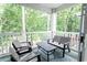 Inviting screened porch with chairs and a bench for enjoying nature at 698 Riverwalk Dr. # 304, Myrtle Beach, SC 29579