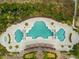 Top-down view of a uniquely shaped pool surrounded by lush vegetation and walkway to the beach at 7545 Ventura Ct., Myrtle Beach, SC 29572