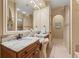Bathroom featuring double vanity with marble countertops, large mirror, and tile flooring, with natural light at 7545 Ventura Ct., Myrtle Beach, SC 29572