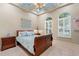 Stylish bedroom with a sleigh bed, blue accents, tray ceiling, and arched windows with plantation shutters at 7545 Ventura Ct., Myrtle Beach, SC 29572