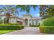 Charming home featuring an elegant facade, arched entryway, manicured hedges and a neatly paved driveway at 7545 Ventura Ct., Myrtle Beach, SC 29572