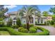 Exterior view of a home with well-maintained landscaping, including a palm tree and manicured hedges at 7545 Ventura Ct., Myrtle Beach, SC 29572