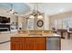 Kitchen featuring a large island with granite countertops, sink, and wooden cabinets at 7545 Ventura Ct., Myrtle Beach, SC 29572