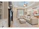 Comfortable living room with a fireplace, large windows, a sofa and an adjacent kitchen at 7545 Ventura Ct., Myrtle Beach, SC 29572