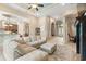 Expansive living room featuring a large sectional sofa, elegant ceiling detail, and an open floor plan to the kitchen at 7545 Ventura Ct., Myrtle Beach, SC 29572