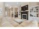 Elegant living room with a fireplace, built-in bookcases, a large white sofa and an adjacent dining room at 7545 Ventura Ct., Myrtle Beach, SC 29572