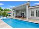 Backyard pool and covered patio with comfortable lounge seating area at 7545 Ventura Ct., Myrtle Beach, SC 29572