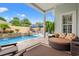 Backyard pool and travertine deck with lounge seating in a resort-style setting at 7545 Ventura Ct., Myrtle Beach, SC 29572