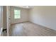 Bright bedroom with wood-look flooring and a large window, creating a comfortable atmosphere at 7611 Coteswood Dr., Myrtle Beach, SC 29572